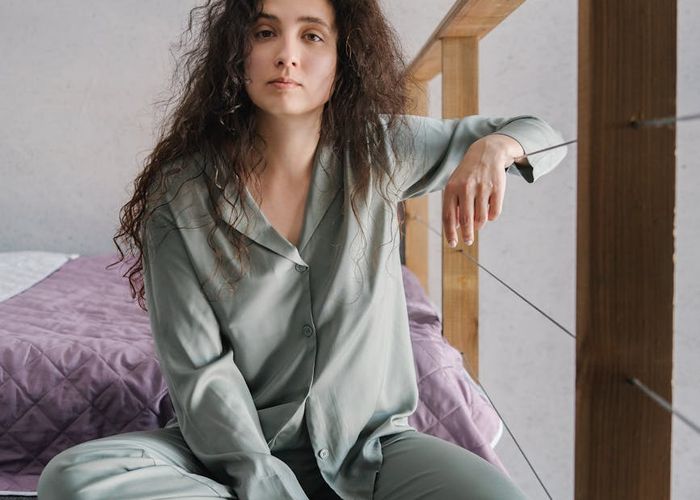 Person meditating peacefully in a room with soft natural light.